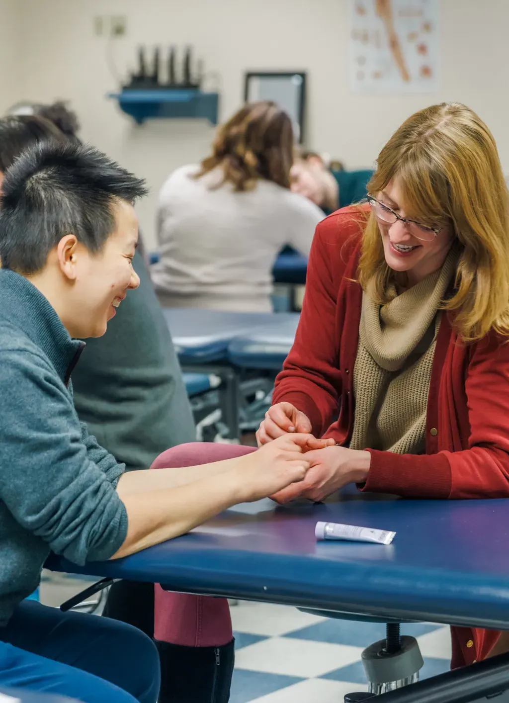 Two D P T students practice hand therapy in class