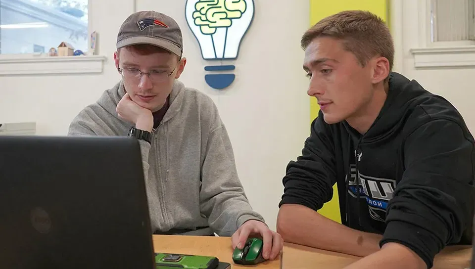 Image of students in the makerspace working on laptops